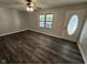 Bright living room featuring modern vinyl flooring, fresh paint, and natural light from the window at 315 Schoolhouse Rd, Franklin, IN 46131
