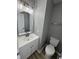 Well-lit bathroom featuring a toilet, vanity, mirror and wood-look flooring at 3327 Brandenburg Blvd, Indianapolis, IN 46239