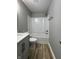 Bright bathroom with a modern gray vanity, stone countertop, and a tub shower combo at 3327 Brandenburg Blvd, Indianapolis, IN 46239