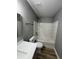 Bathroom showcasing white tiled bathtub, a modern vanity, and wood-look flooring at 3327 Brandenburg Blvd, Indianapolis, IN 46239