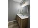 Updated bathroom with wood-look flooring and a modern vanity at 3327 Brandenburg Blvd, Indianapolis, IN 46239