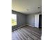 Bedroom with wood-look flooring and a window overlooking the backyard at 3327 Brandenburg Blvd, Indianapolis, IN 46239