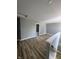 Spacious bonus room with wood flooring, neutral walls and staircase view at 3327 Brandenburg Blvd, Indianapolis, IN 46239