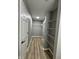 Walk-in closet with wood-look flooring and built-in shelving for optimal storage at 3327 Brandenburg Blvd, Indianapolis, IN 46239
