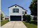 Charming two-story home features a dark garage door, white siding, and manicured lawn at 3327 Brandenburg Blvd, Indianapolis, IN 46239
