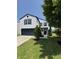 Inviting two-story home with landscaped front yard, featuring a black front door at 3327 Brandenburg Blvd, Indianapolis, IN 46239