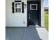Close-up of front door with black trim, classic window, and gray painted walkway at 3327 Brandenburg Blvd, Indianapolis, IN 46239