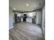 Modern kitchen with stainless steel appliances, white cabinets, and gray backsplash at 3327 Brandenburg Blvd, Indianapolis, IN 46239