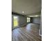 Spacious living room with wood floors and a sliding door to the backyard at 3327 Brandenburg Blvd, Indianapolis, IN 46239