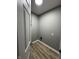 Utility room featuring wood-look flooring, utility hookups, and fresh gray paint at 3327 Brandenburg Blvd, Indianapolis, IN 46239