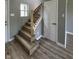 Newly renovated stairs with wood steps and black iron spindles at 3327 Brandenburg Blvd, Indianapolis, IN 46239