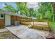 This home features a patio leading to a new wooden deck and a lovely brick facade, offering privacy and style at 3339 Devereaux Dr, Indianapolis, IN 46228