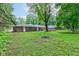 The brick house has a large lush yard with a wooden deck, ideal for outdoor entertaining and relaxation at 3339 Devereaux Dr, Indianapolis, IN 46228