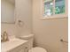 Bright half bath with a white vanity, toilet, and square mirror at 3339 Devereaux Dr, Indianapolis, IN 46228