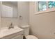 Bright half bath with a white vanity, toilet, and square mirror at 3339 Devereaux Dr, Indianapolis, IN 46228