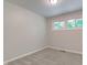 This bedroom boasts neutral paint, new carpet, and a large window with backyard view at 3339 Devereaux Dr, Indianapolis, IN 46228
