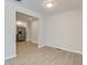 Bright dining room with modern flooring and neutral paint, leading to an updated kitchen at 3339 Devereaux Dr, Indianapolis, IN 46228