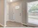 The entryway features a glass detail door and hardwood floors and leads to other areas of the house at 3339 Devereaux Dr, Indianapolis, IN 46228