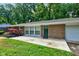 Charming brick ranch home featuring an attached garage and a tree-lined front yard at 3339 Devereaux Dr, Indianapolis, IN 46228