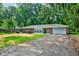 Charming brick ranch home featuring an attached garage and a tree-lined front yard at 3339 Devereaux Dr, Indianapolis, IN 46228