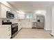 Well-lit kitchen featuring stainless steel appliances, white cabinets, and plenty of counter space at 3339 Devereaux Dr, Indianapolis, IN 46228