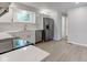 Beautiful kitchen with stainless steel appliances, white cabinets and countertops, and hardwood floors at 3339 Devereaux Dr, Indianapolis, IN 46228