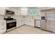 Modern kitchen featuring stainless steel appliances, white cabinets, and new quartz countertops at 3339 Devereaux Dr, Indianapolis, IN 46228