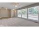 Bright living room featuring large windows and soft carpeting at 3339 Devereaux Dr, Indianapolis, IN 46228