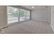 Bright living room featuring large windows and soft carpeting at 3339 Devereaux Dr, Indianapolis, IN 46228