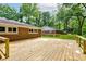 The new wooden deck offers a spacious area for outdoor enjoyment, complementing the home's brick exterior at 3339 Devereaux Dr, Indianapolis, IN 46228