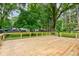 A large wooden deck offers a serene outdoor space with views of the backyard and surrounding mature trees at 3339 Devereaux Dr, Indianapolis, IN 46228