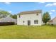 Exterior view of the home's backyard, featuring a well-maintained lawn, patio, and lush greenery at 3623 Carroll Farms Dr, Indianapolis, IN 46235