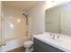 Bathroom with a shower-tub combo, gray vanity with a white sink and a large mirror at 3623 Carroll Farms Dr, Indianapolis, IN 46235