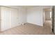 Bedroom featuring carpet, closet with double doors, and an entrance into another room at 3623 Carroll Farms Dr, Indianapolis, IN 46235