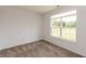 Cozy bedroom with neutral carpeting, a large window, and neutral painted walls at 3623 Carroll Farms Dr, Indianapolis, IN 46235
