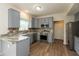 Modern kitchen with gray cabinets, stainless steel appliances, and stylish backsplash at 3623 Carroll Farms Dr, Indianapolis, IN 46235