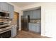Modern kitchen with stainless steel refrigerator, updated cabinets, countertops and backsplash at 3623 Carroll Farms Dr, Indianapolis, IN 46235