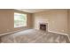 Comfortable living room featuring a classic fireplace, neutral carpeting, and natural light at 3623 Carroll Farms Dr, Indianapolis, IN 46235