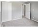 A bedroom features light grey carpet, grey walls, a double door closet, and a doorway at 3627 N Brentwood Ave, Indianapolis, IN 46235