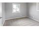 An empty bedroom features light grey carpet, gray walls, and a double hung window at 3627 N Brentwood Ave, Indianapolis, IN 46235
