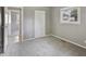 A gray bedroom features light grey carpet, a window and a bi-fold door closet at 3627 N Brentwood Ave, Indianapolis, IN 46235