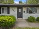 Home featuring a dark front door with sidelight, green bushes, and a 'Welcome' mat at 3627 N Brentwood Ave, Indianapolis, IN 46235