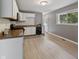 A kitchen features light wood floors, white cabinets, granite countertops, and modern appliances at 3627 N Brentwood Ave, Indianapolis, IN 46235