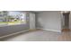 Living room featuring gray walls, light wood floors, and view to the front yard at 3627 N Brentwood Ave, Indianapolis, IN 46235
