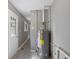 This utility area features light wood floors, grey walls, and modern water heater at 3627 N Brentwood Ave, Indianapolis, IN 46235