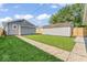 Backyard with grass leading to two sheds at 3716 W 16Th St, Indianapolis, IN 46222