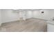 Spacious basement features neutral paint, light gray trim, and wood-look flooring at 3716 W 16Th St, Indianapolis, IN 46222