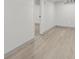 Unfinished basement area with an open doorway and light gray wood-look flooring at 3716 W 16Th St, Indianapolis, IN 46222