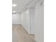 Basement features light gray wood laminate flooring and a door at 3716 W 16Th St, Indianapolis, IN 46222