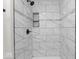 Updated shower featuring tiled walls, mosaic accents, and sleek fixtures at 3716 W 16Th St, Indianapolis, IN 46222